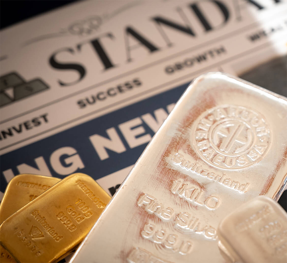 Gold and silver bars on a newspaper
